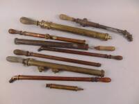 Various brass and copper garden syringes.