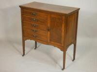 An Edwardian walnut music cabinet