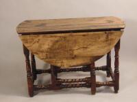 An early 18thC oak oval drop leaf table