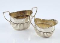 A late Victorian silver semi-fluted cream jug and matching sugar basin