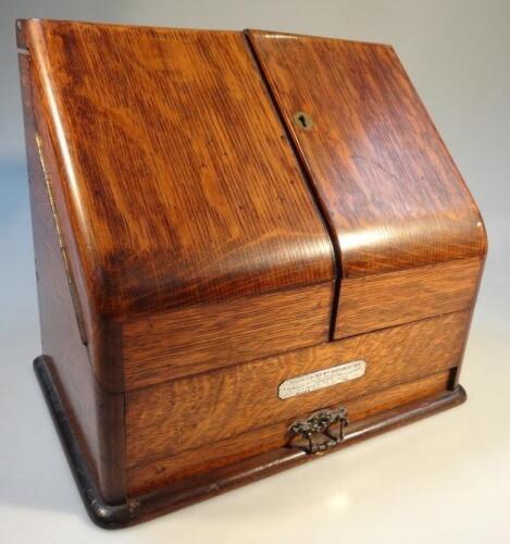 An Edwardian oak stationery cabinet