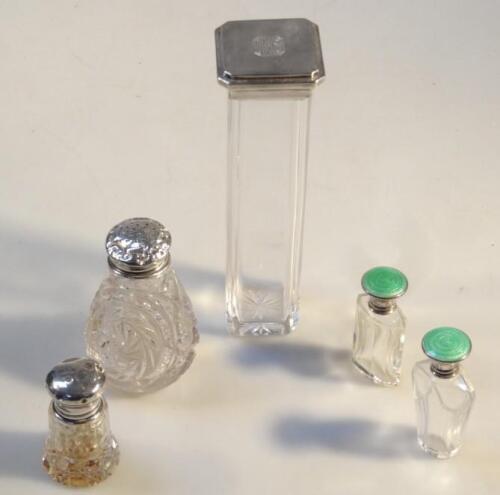 A quantity of Victorian and later silver topped glass dressing table bottles