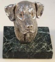 A silver bust of a dog's head