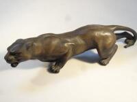 A mid-20thC figure of a crouching puma