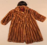 A three quarter length fur coat and a fur hat. (2)