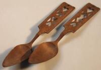 A pair of heavily carved wooden Welsh serving spoons