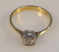 A Continental yellow metal diamond solitaire ring