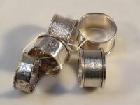 A harlequin set of five George V & later silver napkin rings