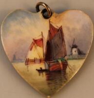 A heart shaped porcelain pendant painted by James Edwin Dean