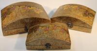 A graduated set of three oriental design dome topped caskets