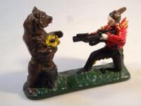 A cast metal shooting bear money box