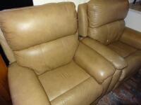 A pair of tan leather electric reclining armchairs