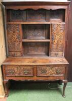 A heavily carved oak dresser