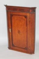 A George III oak and mahogany corner cupboard