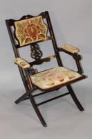 A stained Edwardian folding armchair