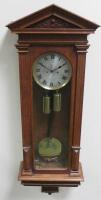 An early 20thC oak cased Vienna wall clock