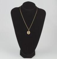 A modern 9ct gold and seed pearl pendant