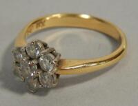 An 18ct gold and seven stone diamond flowerhead cluster ring