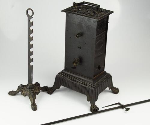 A cast iron spit roaster with clockwork mechanism