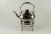 A silver plated tea kettle and stand