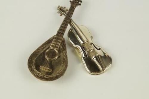 Two modern white metal miniature musical instruments