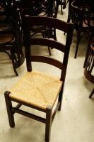 A set of six stained beech and rush seated ladderback chairs.