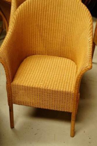 Four Lloyd Loom tub chairs.