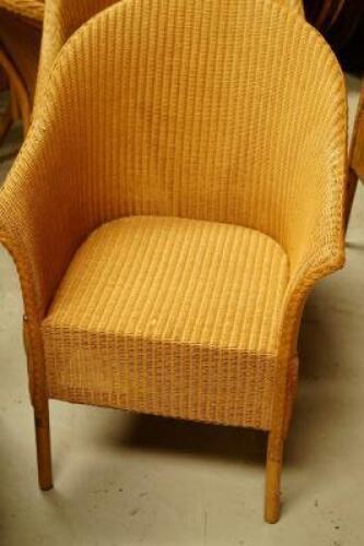 Four Lloyd Loom tub chairs.