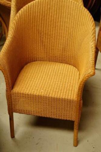 Four Lloyd Loom tub chairs.