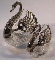 A graduated pair of white metal swan bonbonieres