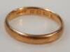 A plain 22ct gold wedding band