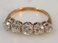 An 18ct gold and platinum half hoop five stone diamond ring