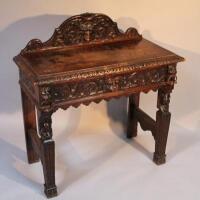 A late 19thC oak hall table of heavily carved form