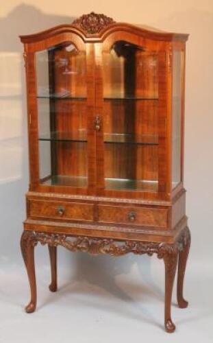 A 20thC walnut finished display cabinet