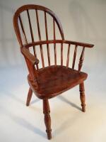 A 19thC elm and ash child's Windsor chair. of typical form