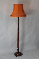 An ebonised turned wooden floor lamp