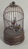 A reproduction Swiss style musical bird cage
