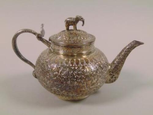 An Indian white metal teapot