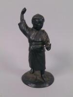 A Japanese bronze figure of an oriental child catching a fish