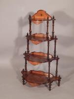 A Victorian burr walnut and boxwood strung four tier whatnot