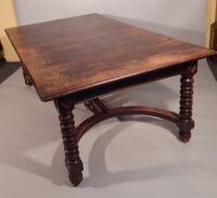 A large early 20thC oak extending dining table