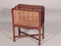 An early 20thC mahogany and caned two-tier Canterbury