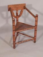 A late 19thC / early 20thC oak turners chair with chip carving and triangular solid seat.