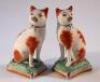 A pair of 19thC Staffordshire pottery cats