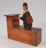 An Edwardian oak articulated money box