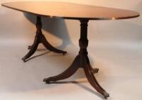 A mahogany finished twin pillar D-end dining table