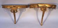 A pair of gilt wood console tables
