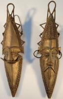 A pair of gilt metal African tribal masks