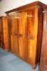 A George V figured mahogany triple hanging wardrobe