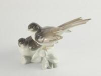 A Lladro figural group of two doves.